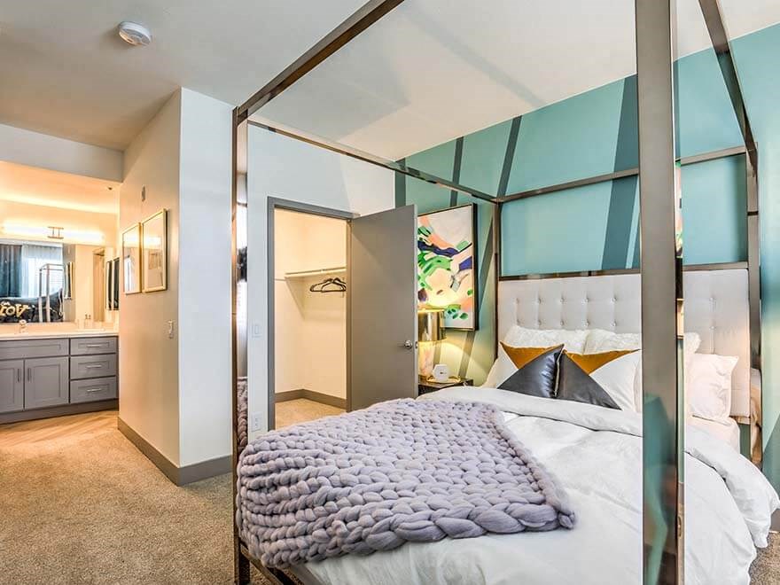 a bedroom with a large bed and a mirror