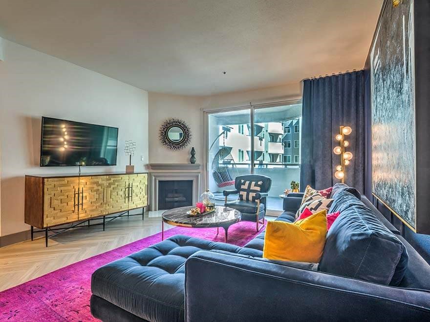 a living room with a blue couch and a tv