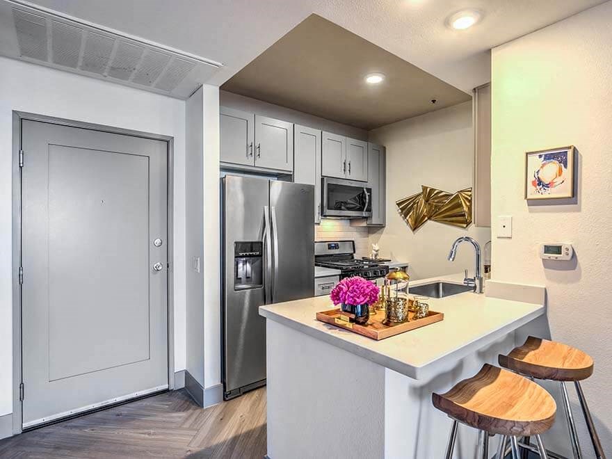 a kitchen with a counter top and a refrigerator