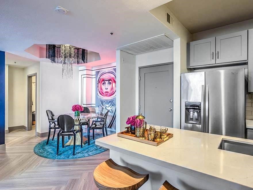 a kitchen and dining room with a table and a refrigerator