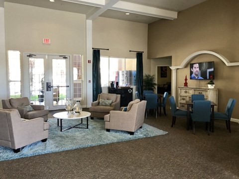 a living room with chairs and couches and a table