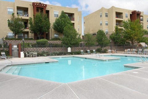 a large swimming pool in front of an apartment building