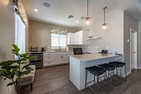 a kitchen with a counter top and three stools