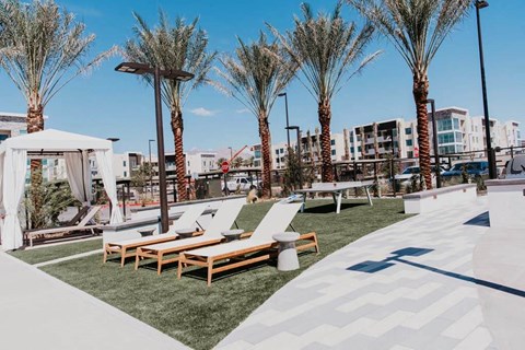 a pool with lounge chairs and a gazebo