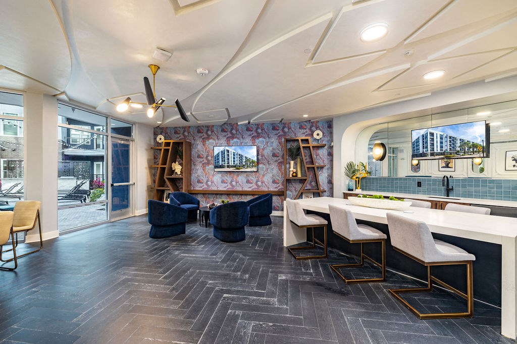 a room with a long table with chairs and a large mirror on the wall