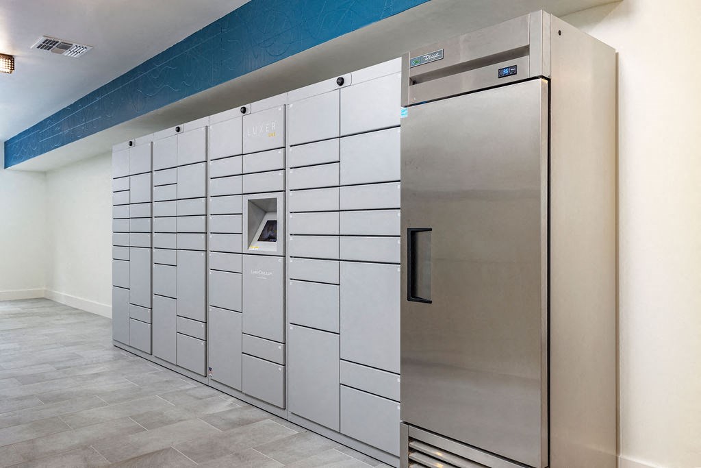 a row of lockers in a room with a tile floor and a blue and white wall