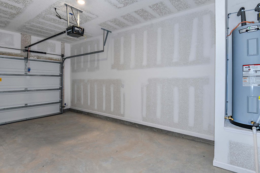 a garage with white walls and a blue water heater