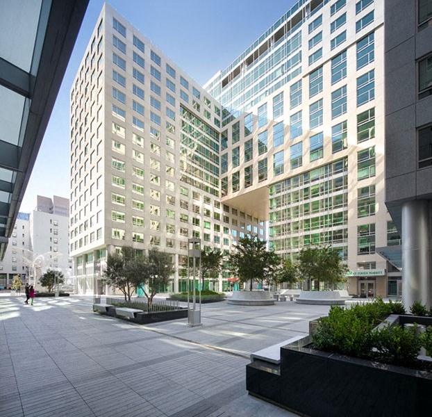 a rendering of a large office building with a plaza in front of it