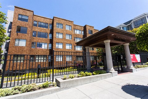 a large brick building with a wooden podium in front of it