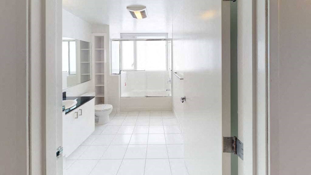 a bathroom with a toilet a sink and a window