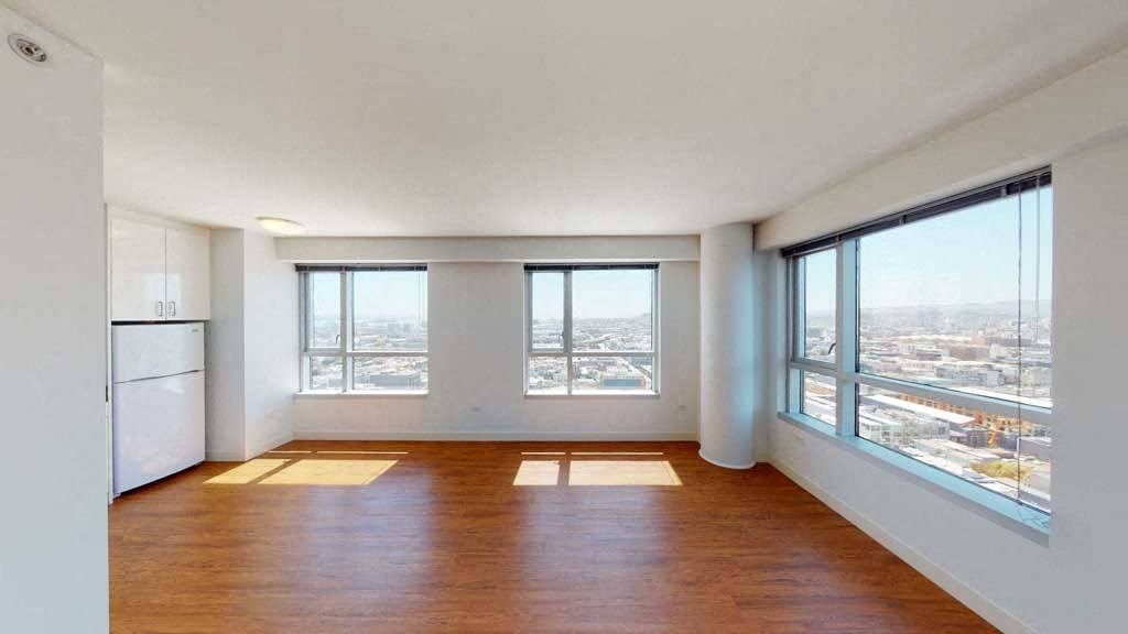 an empty living room with a view of the city