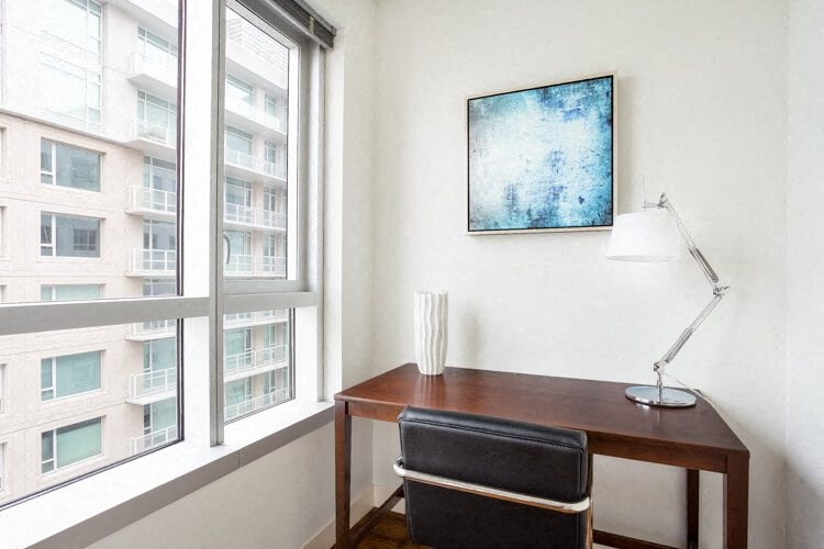 a desk with a chair and a lamp in a room