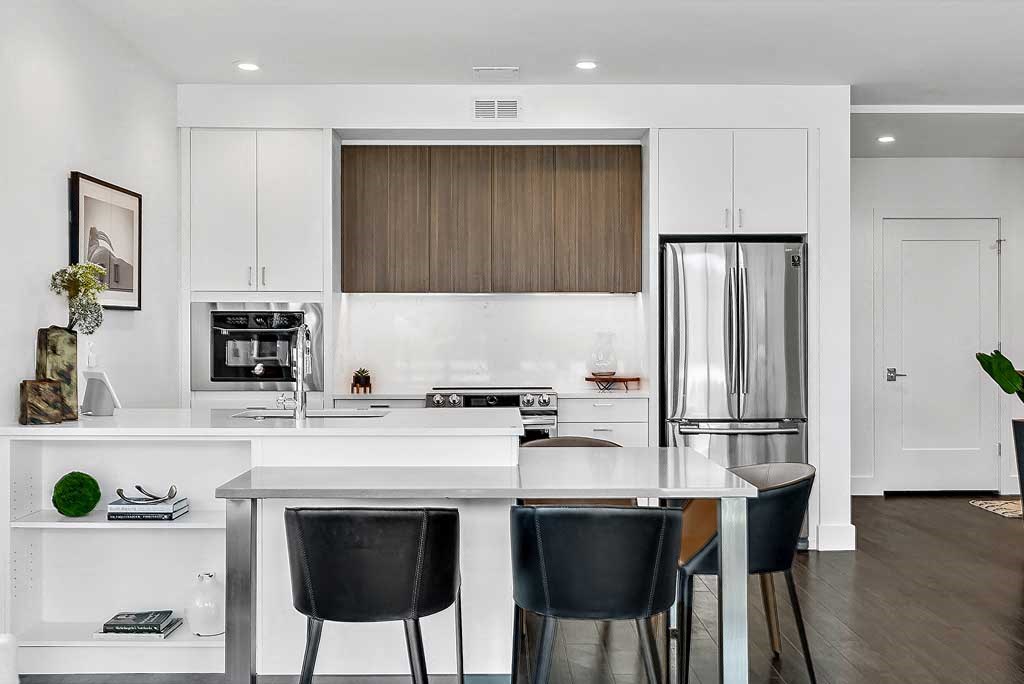 a kitchen with a center island next to a stove top oven