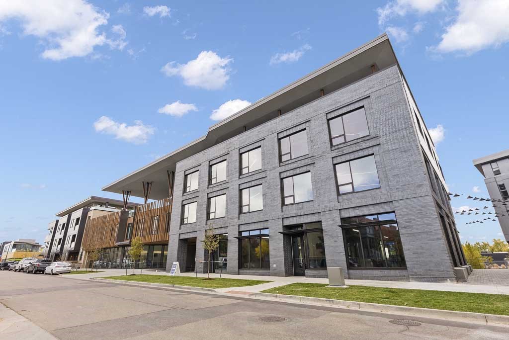 a large gray building with a blue sky in the background