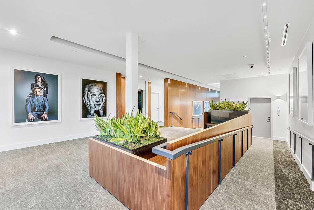 a building with a reception desk with plants on it