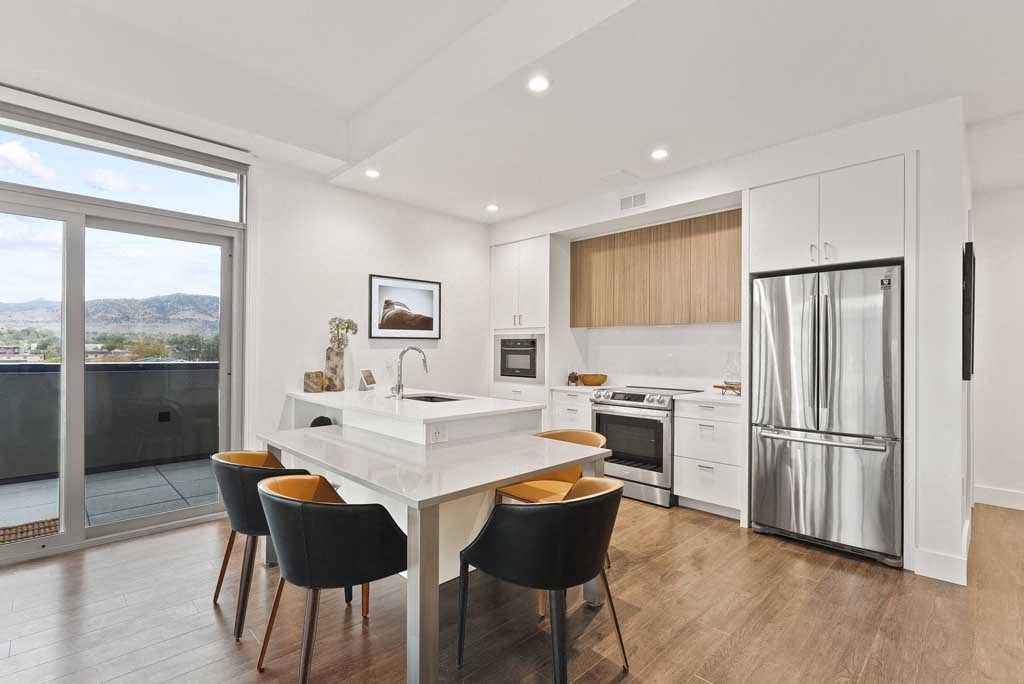 a kitchen with a refrigerator freezer next to a stove top oven