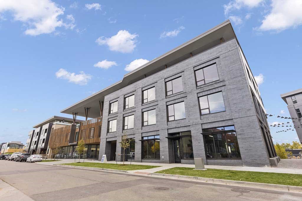 a large gray building with a blue sky in the background