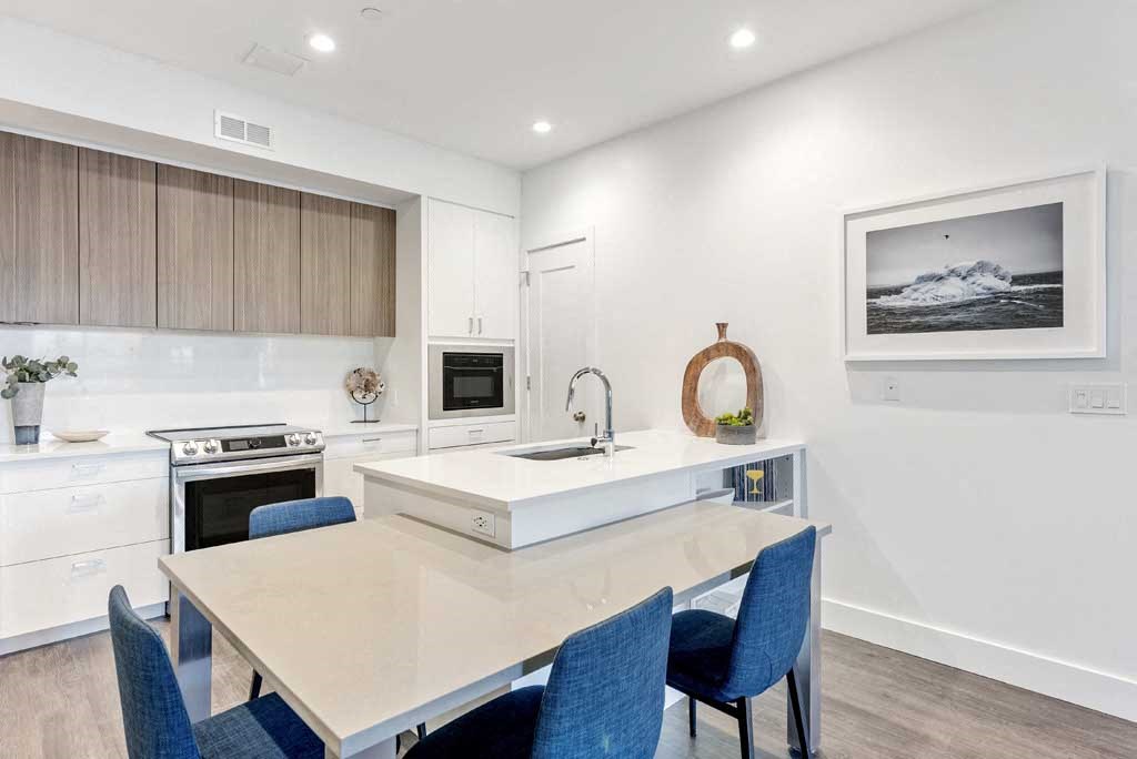 a kitchen with a sink and a stove in a room