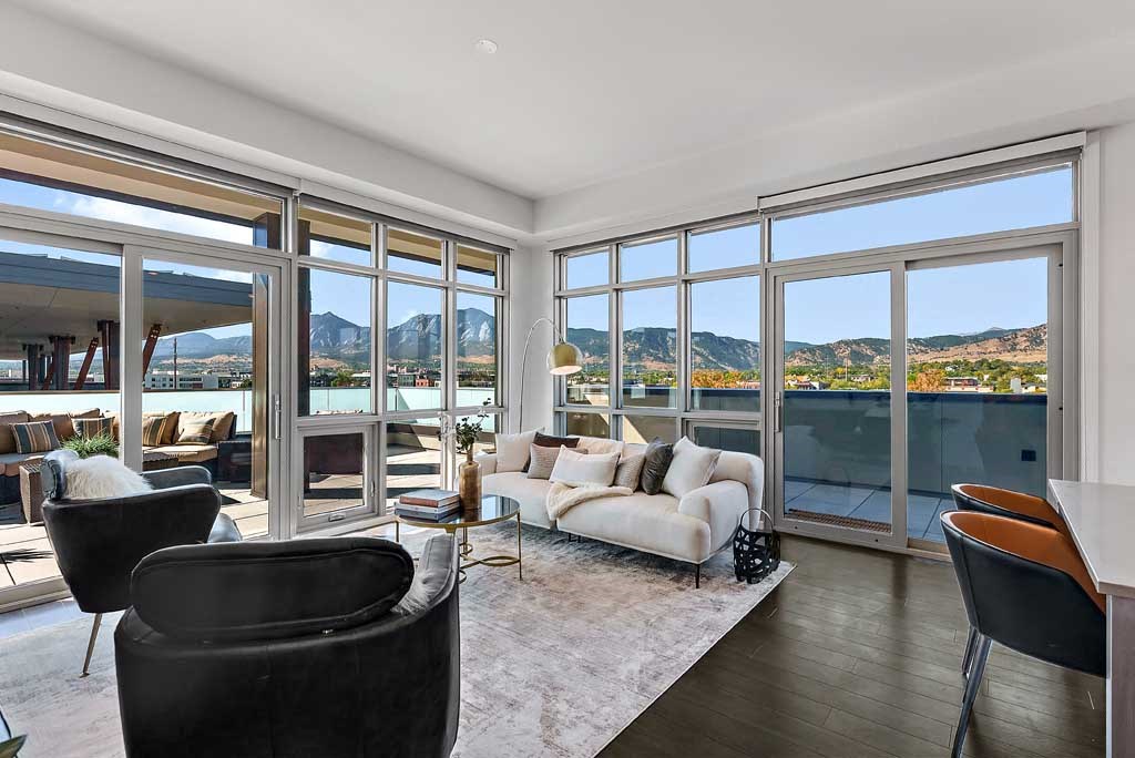 a living room filled with furniture and a large window