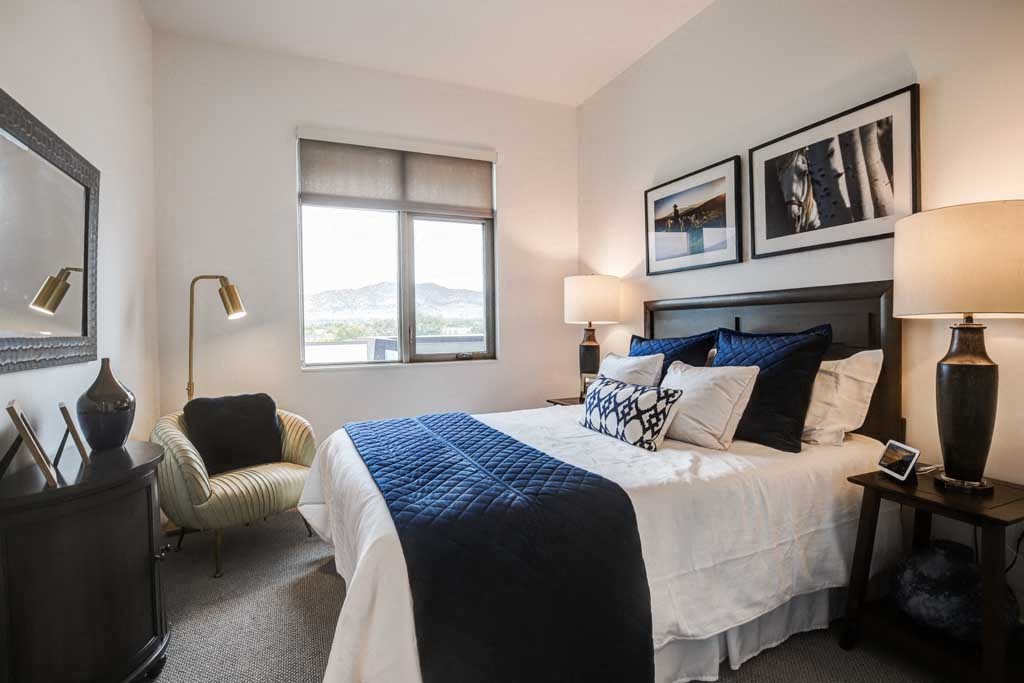 a bedroom with a bed and a chair