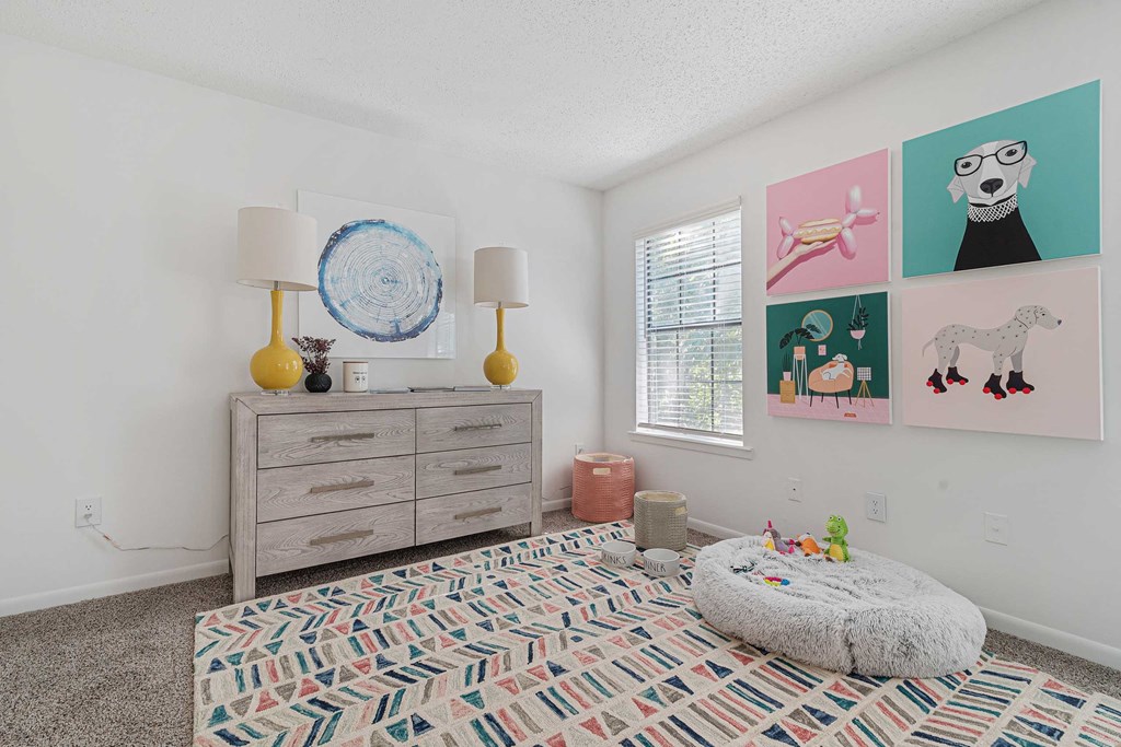 a bedroom with a dresser and a window