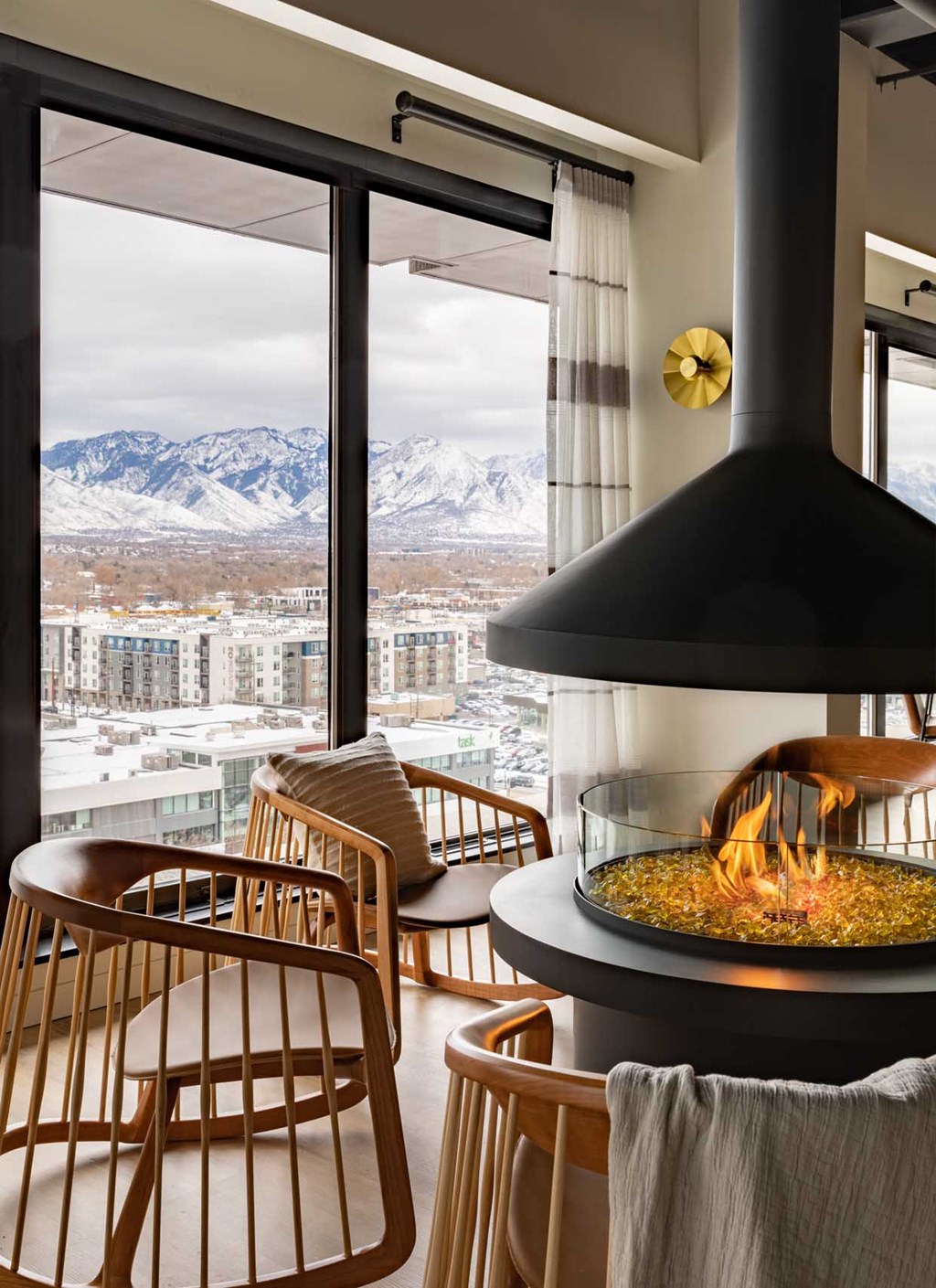 a fireplace in a hotel room with a view of the mountains
