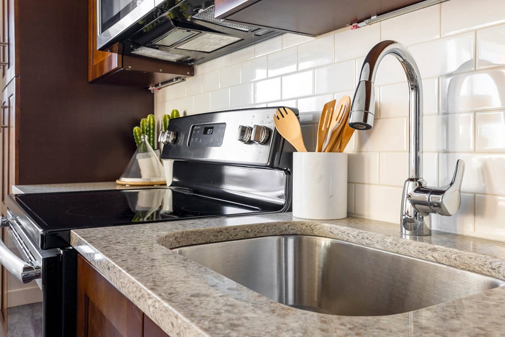 a kitchen with a sink and stove in a 555 waverly unit