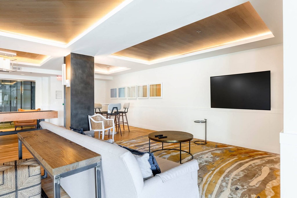 a living room with a white couch and a wooden coffee table
