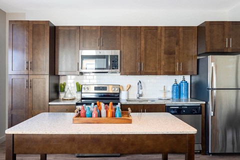 a kitchen with stainless steel appliances and wooden cabinets