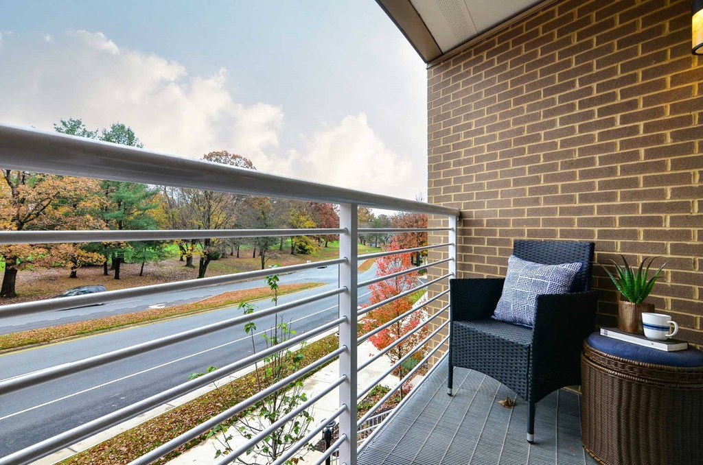 a balcony with a chair and a table