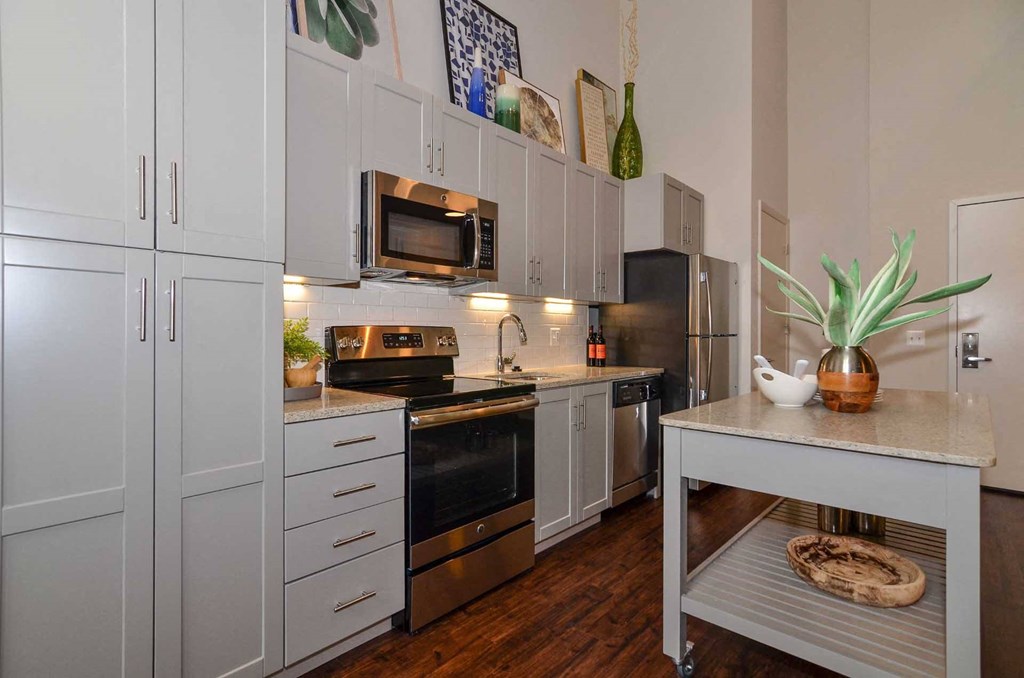 a kitchen with white cabinets and stainless steel appliances