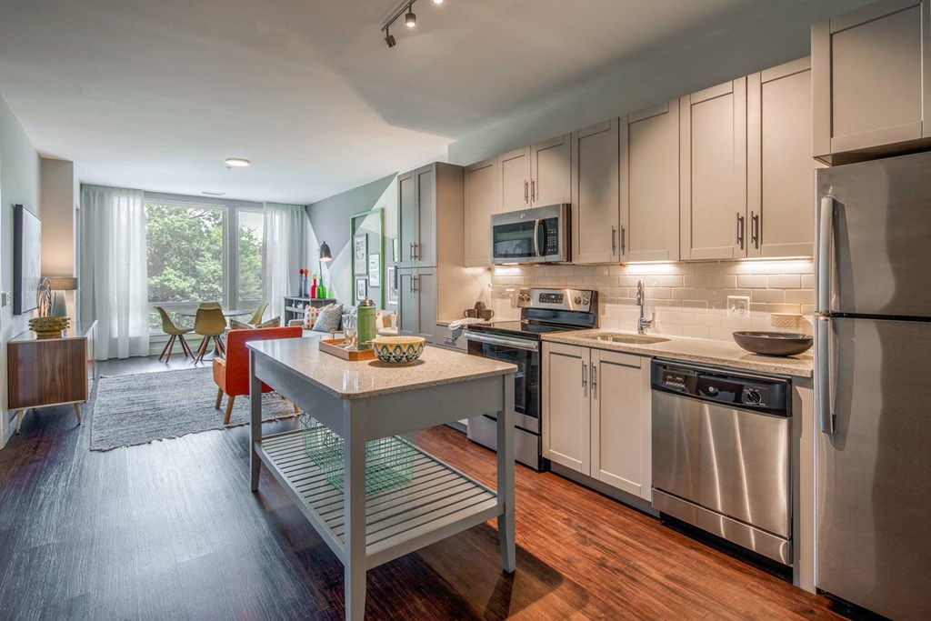 a kitchen with white cabinets and stainless steel appliances