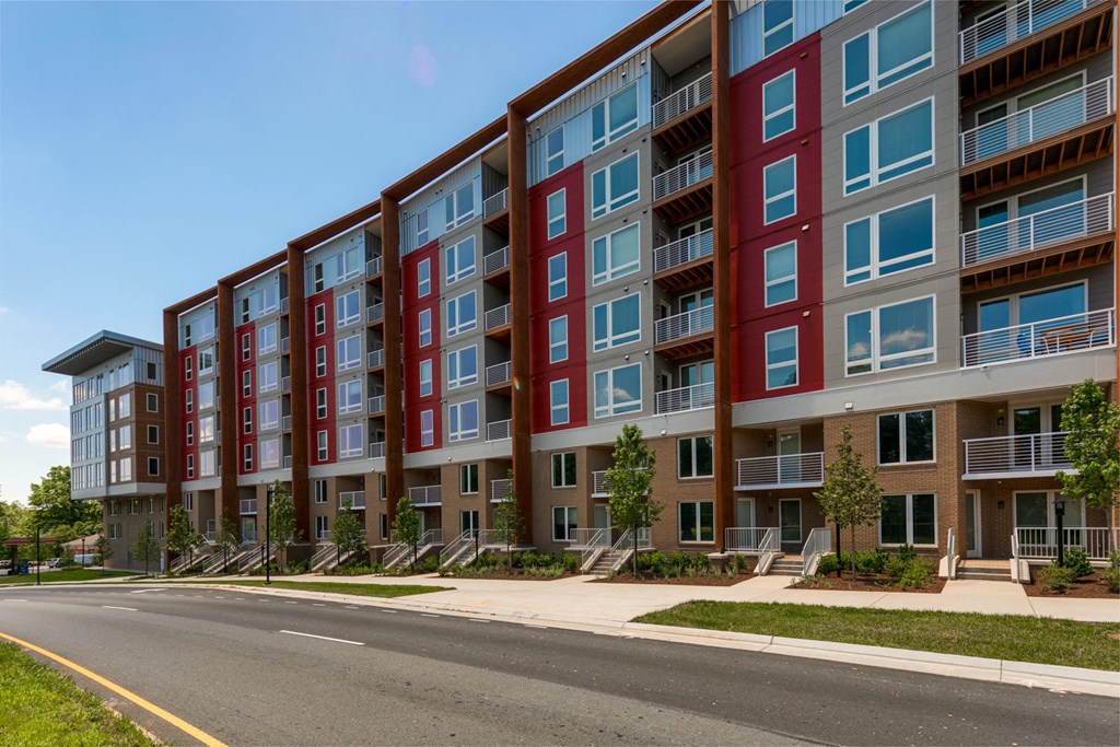 a large apartment building with red and blue exterior walls