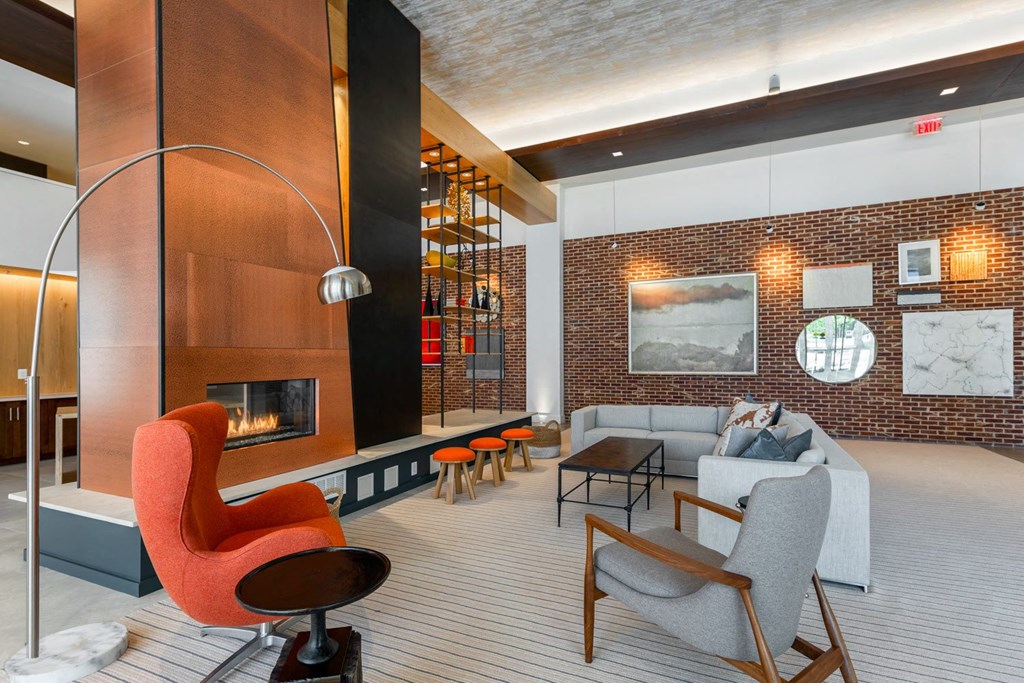 a living room filled with furniture and a large fireplace