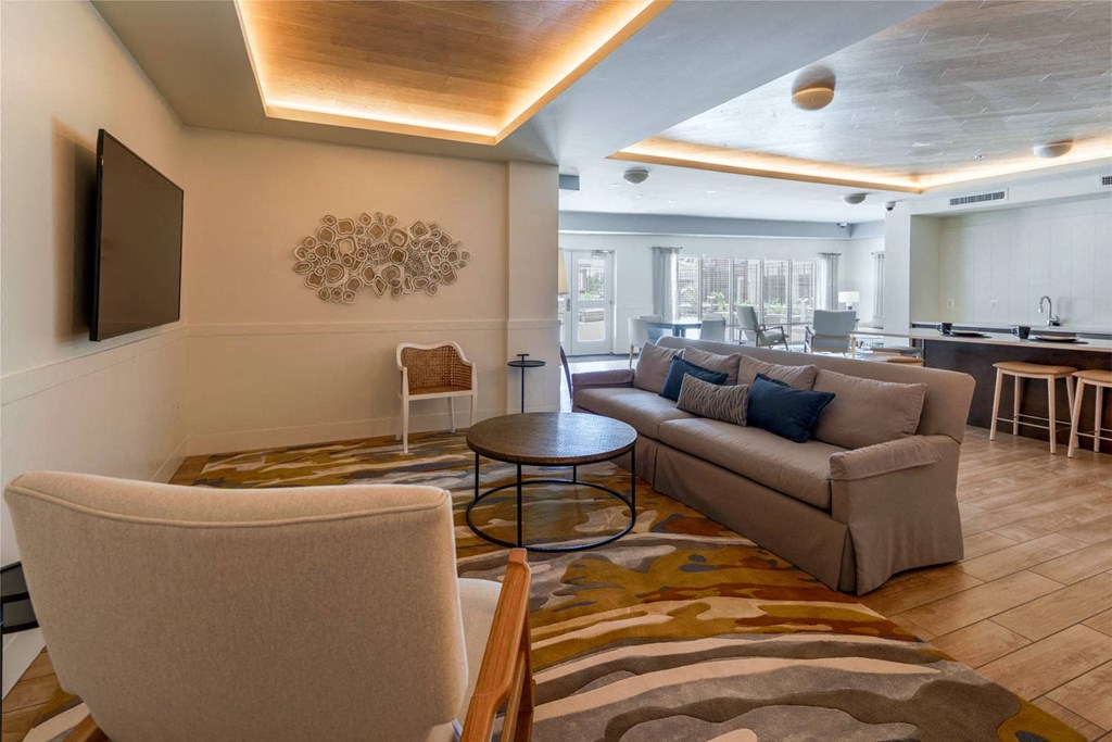 a living room filled with furniture and a flat screen tv