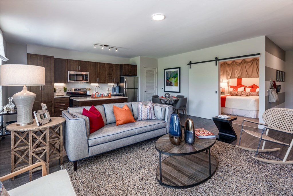 a living room filled with furniture and a large window