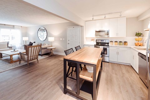 A kitchen with a table and chairs in the middle of the room.