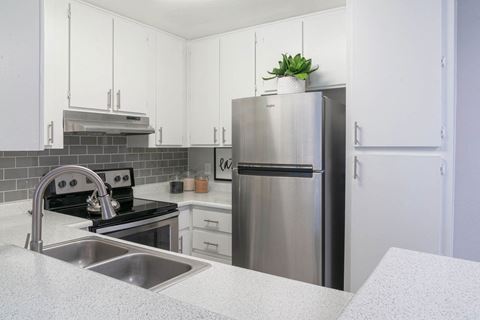 a kitchen with white cabinets and a stainless steel refrigerator at Westmount at Urban Trails, Mesa, AZ 85202