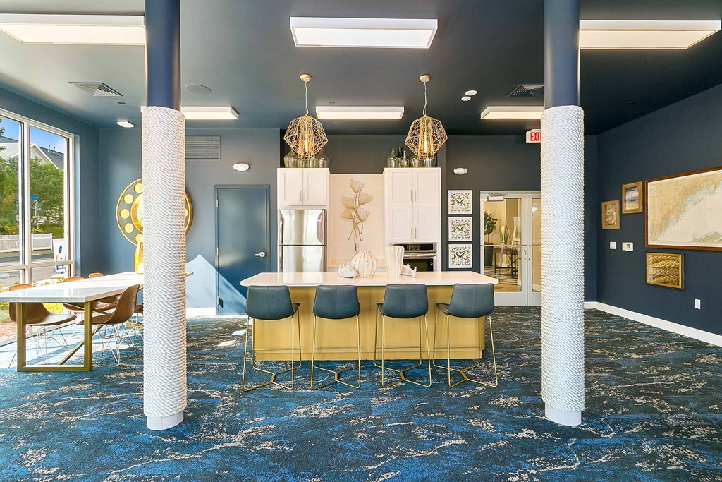 a view of the lobby with blue carpeting and blue pillars with gold chairs