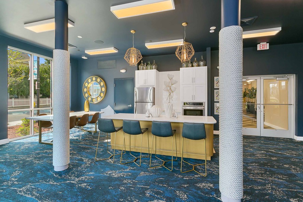 a room with blue carpeting and blue pillars