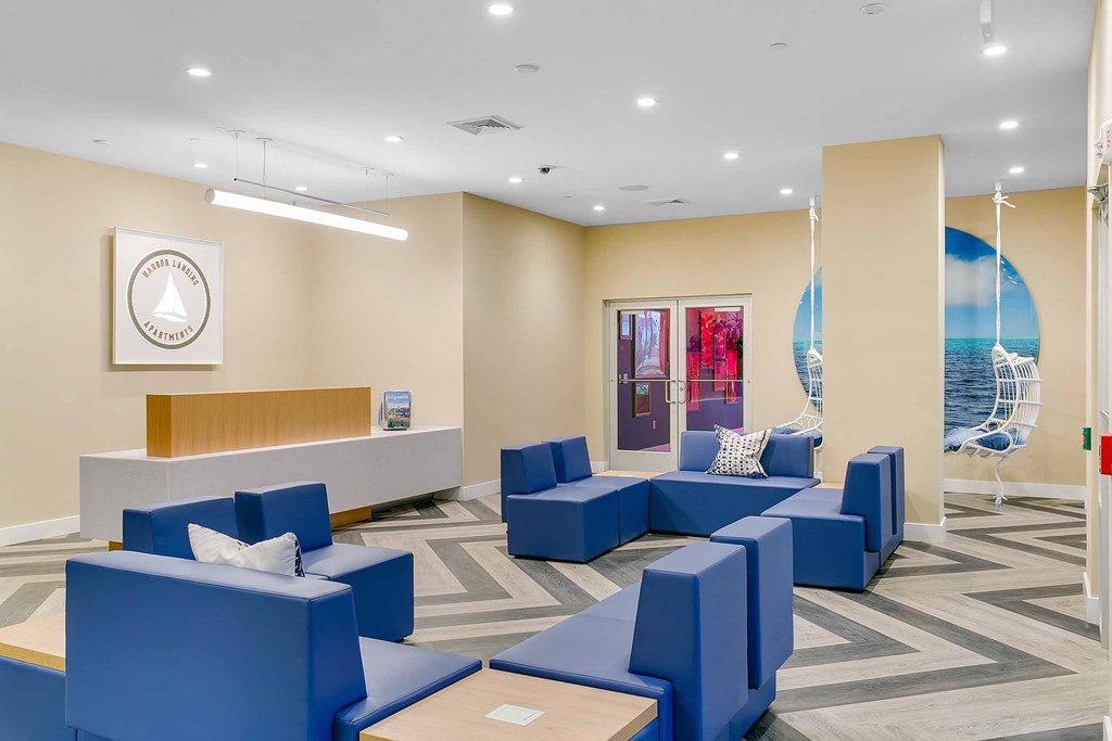 a lobby with blue couches and chairs