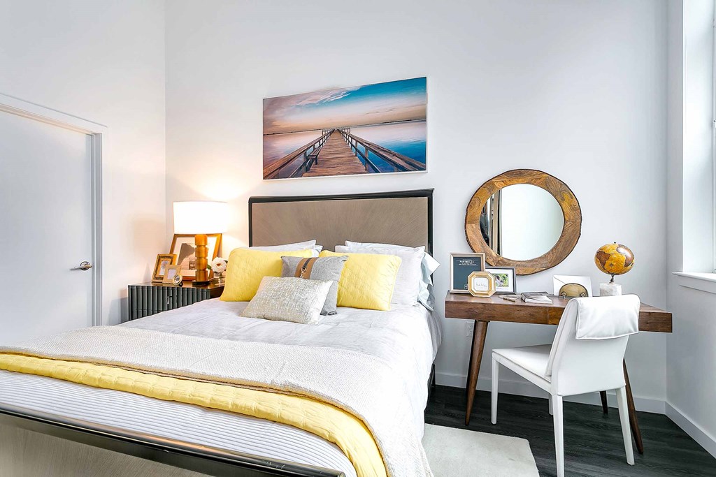 a bedroom with a bed and a desk