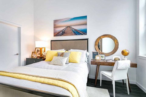 a bedroom with a bed and a desk