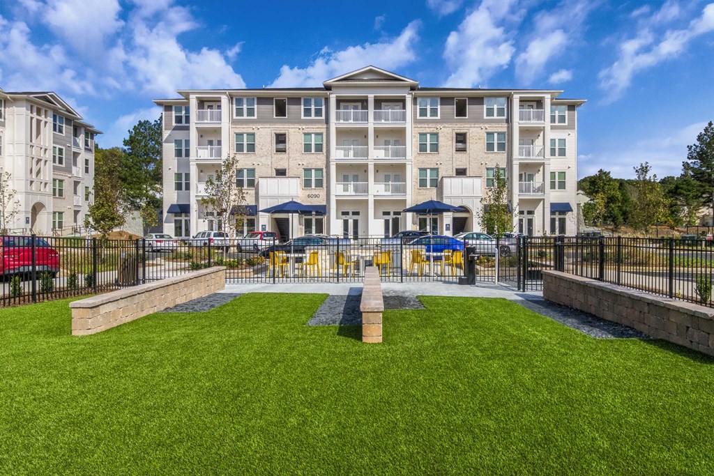 a courtyard with a fountain and an apartment building in the background