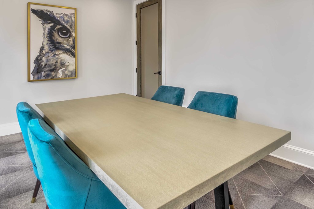 a dining room table with three blue chairs
