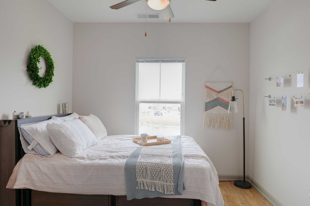 a bedroom with a bed and a window