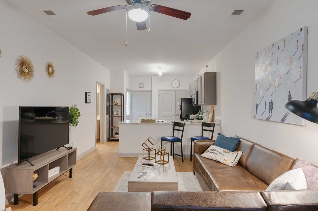 a living room with a couch and a ceiling fan