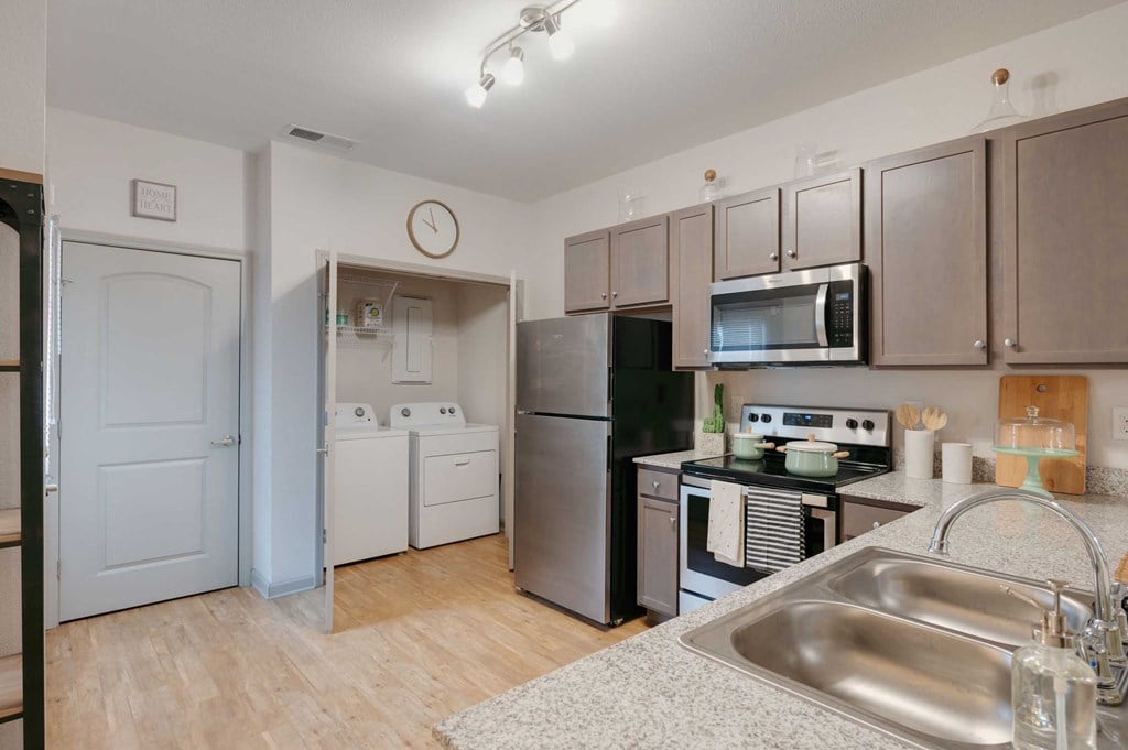 a kitchen with stainless steel appliances and a sink