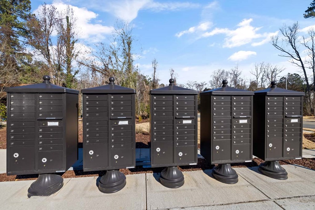 a row of mailboxes sitting on a sidewalk