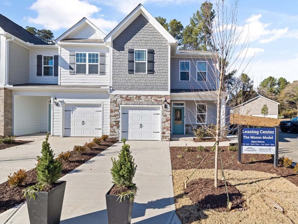 a home for sale with a sign in front of it